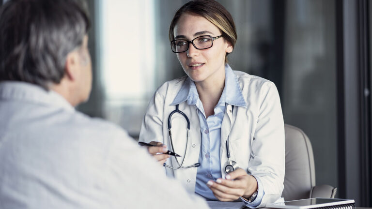 Female doctor talking with male patient