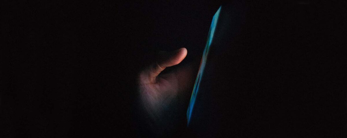 Person using phone in the dark