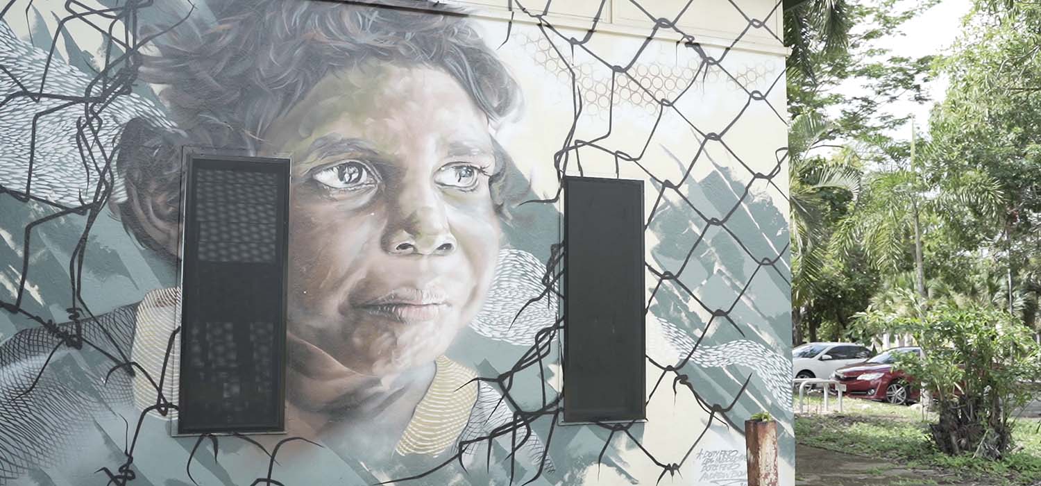 Mural of Aboriginal person on a wall in Darwin